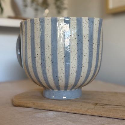 Opposite side of the mixing bowl showing continuous blue and cream stripes.