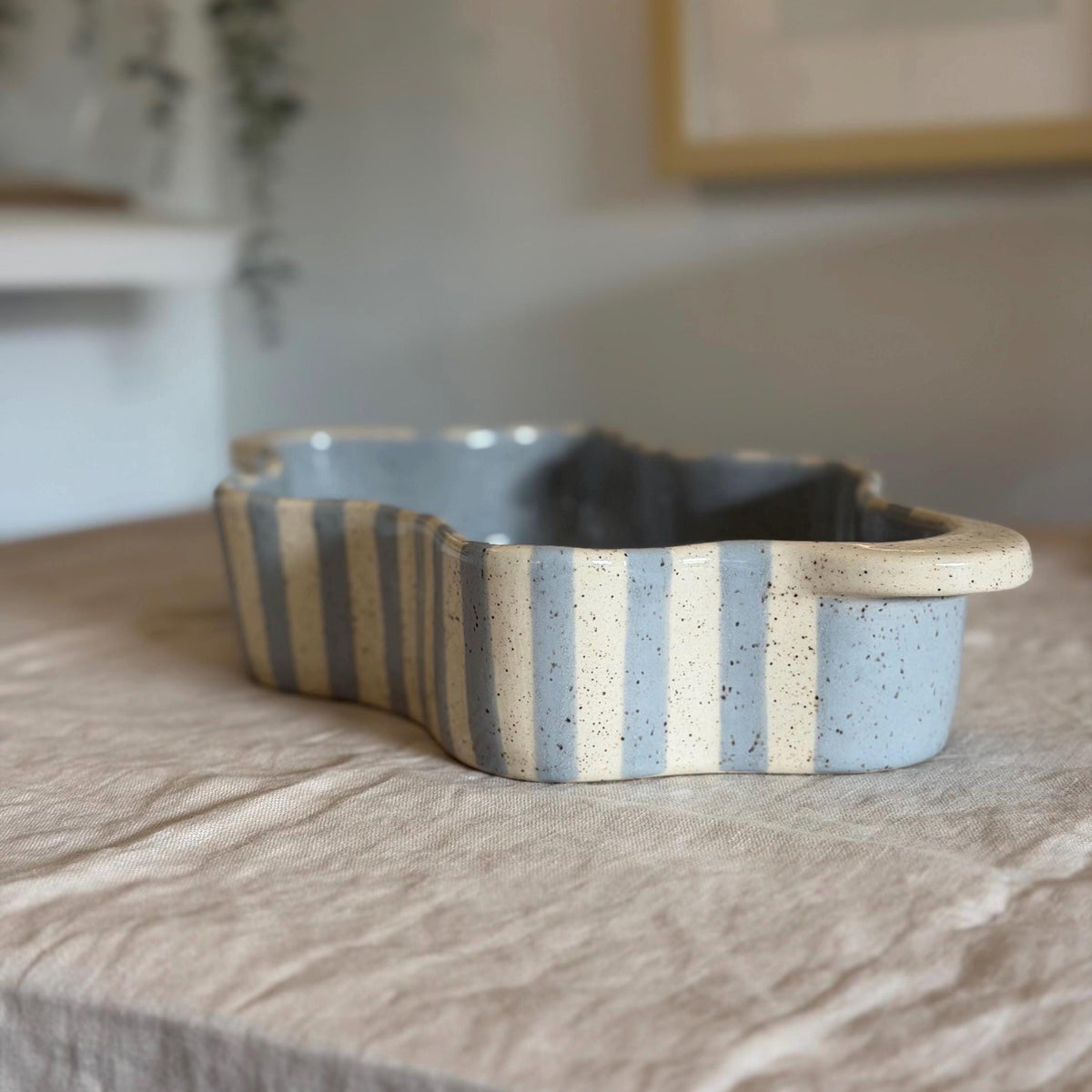 End view of the wavy striped dish with its broad cream handle.