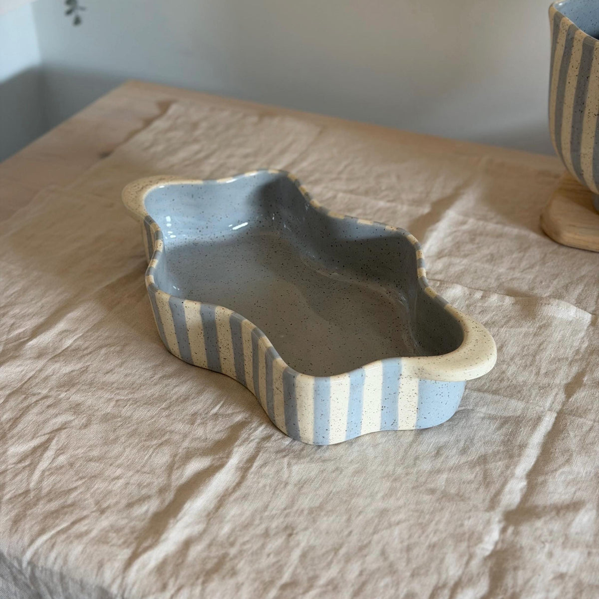 Lengthwise view into the blue-striped wavy baking dish.