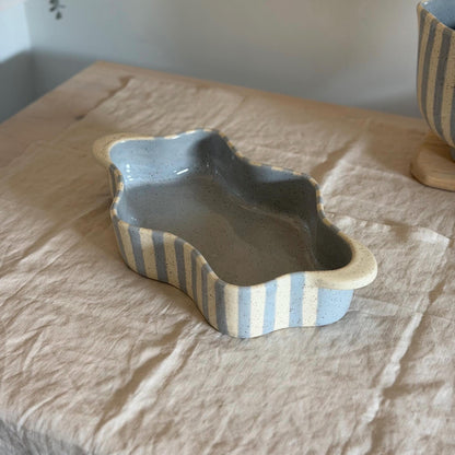 Lengthwise view into the blue-striped wavy baking dish.