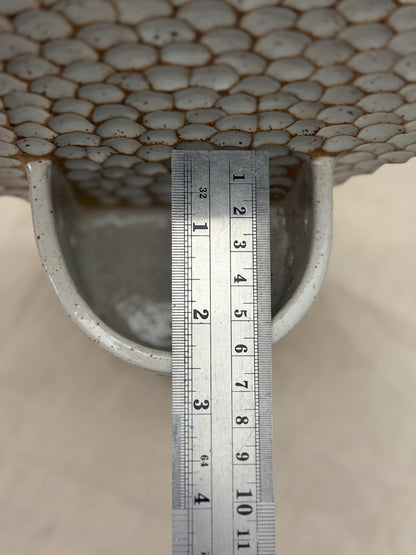 Ruler measuring the depth of the honeycomb wall holder's candle cup.