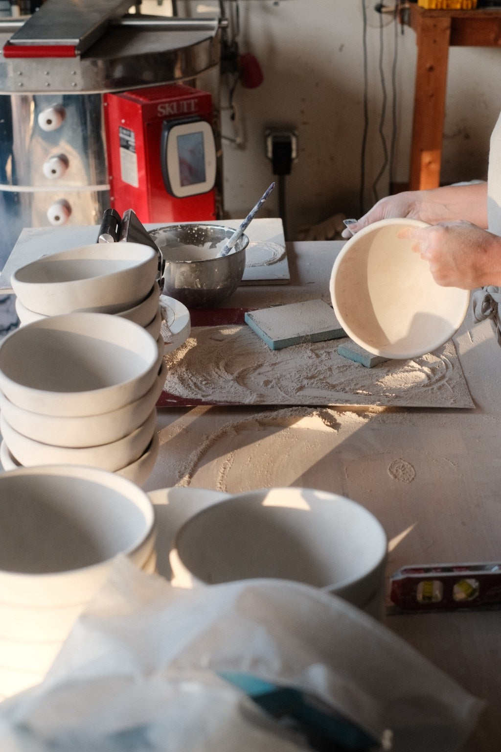 Handmade bowls being finished in the studio