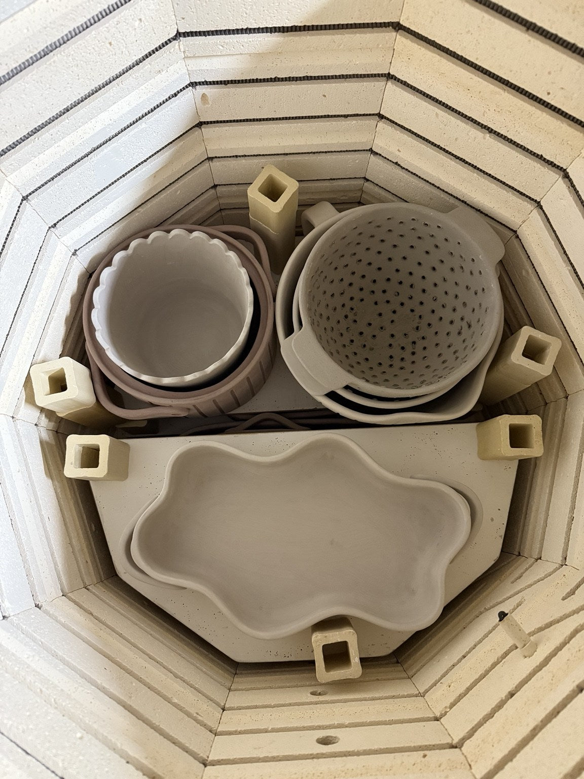 Bowls and baking dishes arranged inside the kiln