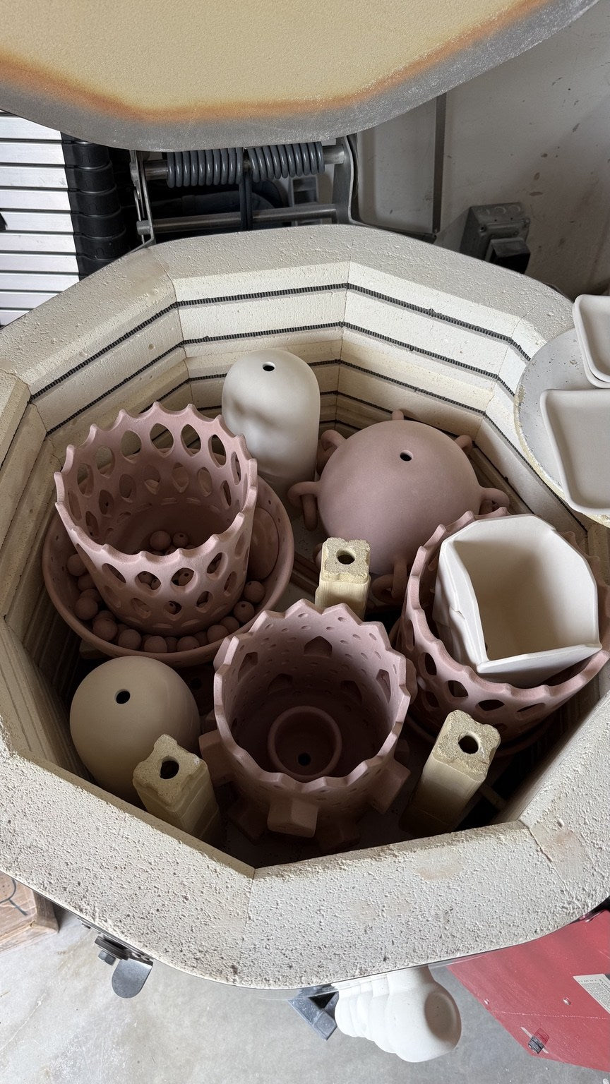 A kiln filled with handmade ceramic pieces