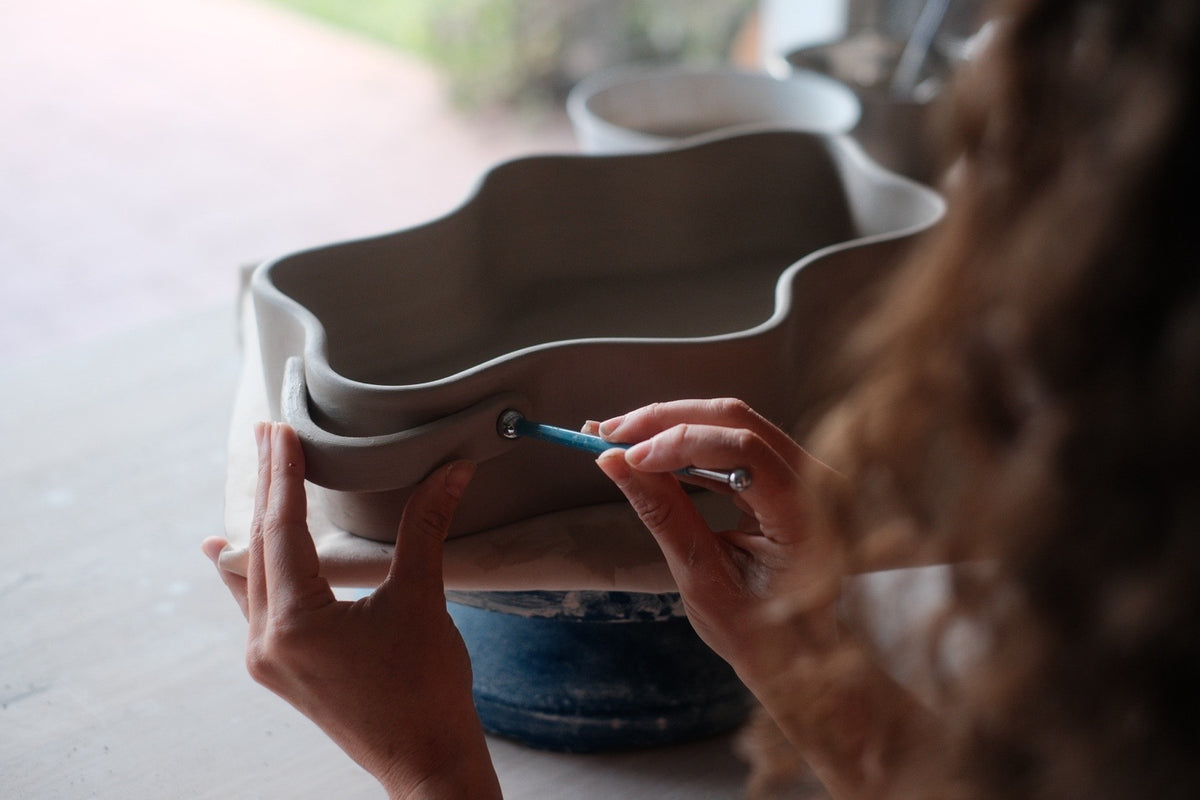 Mine adding details to a handbuilt wavy baking dish